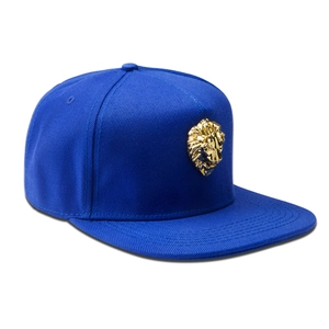 Close-up of royal blue flat brim cap with a 3D golden lion head metallic emblem
