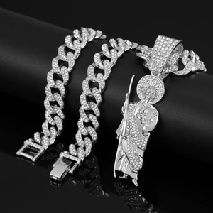 Macro shot of iced out silver hip hop jewelry set with religious portrait pendant