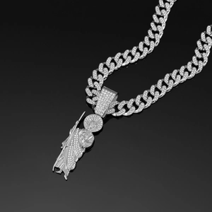 Close-up of iced out Cuban link chain with detailed Saint Jude pendant in silver tone
