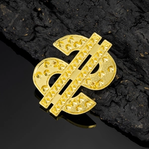 Macro shot of gold dollar sign metal badge with 3D rivet texture on dark wood background