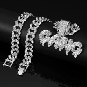 Detailed close-up of iced out silver Cuban link chain with a sparkling GANG pendant