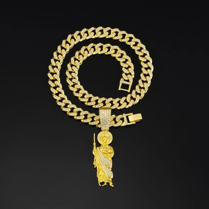 Close-up of hip hop gold Cuban link chain with St. Jude pendant and pavé rhinestones
