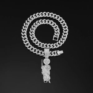 Macro view of iced out Cuban link chain with Saint Jude pendant and silver rhinestones