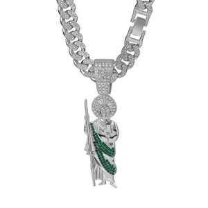 Macro shot of silver Cuban link necklace with iced out Saint Jude religious pendant