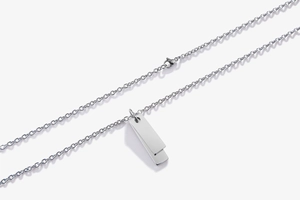 Detail view of double rectangular tag necklace with a polished mirror silver finish