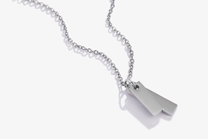 Macro detail of double rectangular titanium steel pendants with polished silver finish