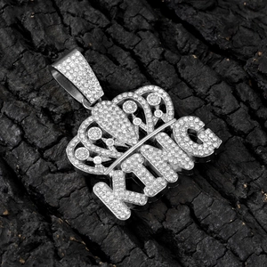 Close-up of hip-hop silver alloy KING crown pendant with shimmering rhinestones