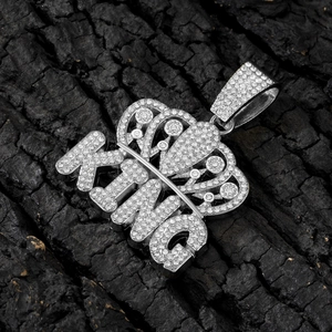 Hip hop silver KING crown pendant with sparkling cubic zirconia on rustic wood background