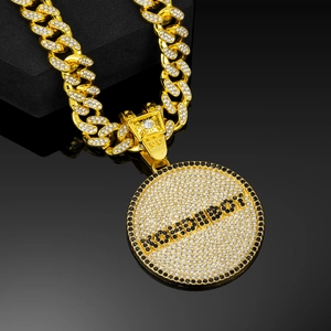 Detalle de cadena cubana dorada con colgante de letras RODIBBOY e incrustaciones