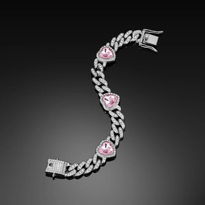 Silver Cuban link bracelet with sparkling pink heart gemstones on black mirror background