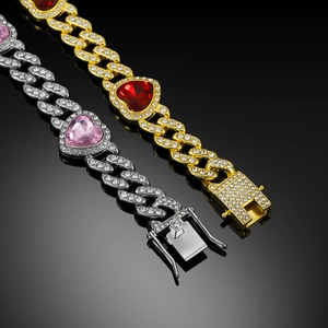Detail view of gold and silver cuban chains with sparkling heart-shaped crystals
