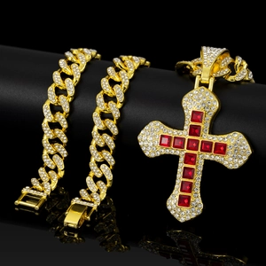 Close-up of hip hop golden cross pendant with red square stones and Cuban link chain