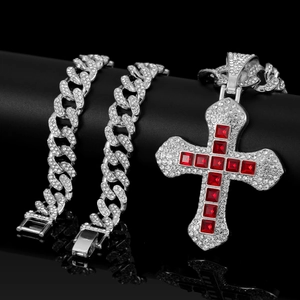 Detailed macro of hip hop silver cuban chain and cross pendant with red square gems