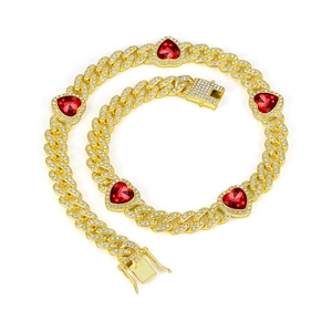 Close-up of gold Cuban chain with red heart gems and white diamond-encrusted links