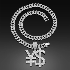 Macro shot of silver hip hop Cuban chain with iced-out dollar and yen symbol pendant