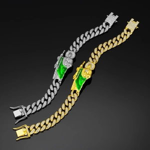 Detail of St. Jude hip-hop bracelets in gold and silver finish with green enamel and diamonds