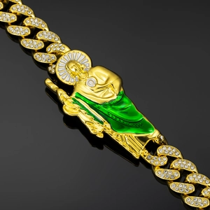 Macro detail of St. Jude hip hop bracelet with green enamel and paved stones
