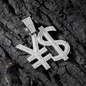 Macro shot of iced-out dollar and yen symbol pendant with sparkling pavé rhinestones