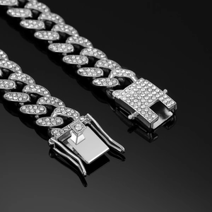Detailed macro view of iced out silver Cuban link chain with secure clasp and diamonds