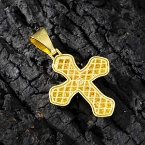 Hip hop style gold cross pendant with hollow mesh texture on a black charcoal background