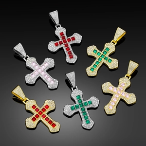 Detail of hip hop cross pendants with colorful square stones on black reflective glass