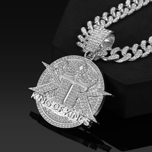Macro shot of silver hip-hop King of Kings pendant with cuban chain and shiny rhinestones