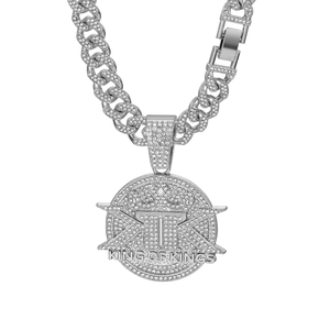 Macro shot of silver hip-hop pendant with KING OF KINGS text and iced-out rhinestones