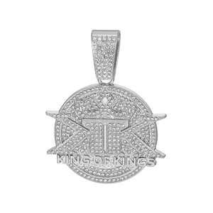 Macro shot of silver hip-hop pendant with iced-out crystals and King of Kings text