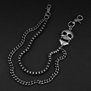 Detail view of punk style double-layered metal wallet chain with silver skull pendant