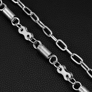 Macro shot of industrial punk style spring and bike chain link on black leather background