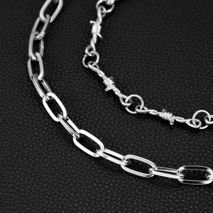 Detailed close-up of double-layer silver metal pants chains with a punk thorn wire design