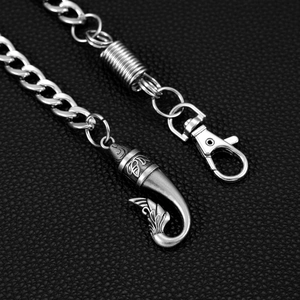 Hip-hop style pants chain with vintage fishtail hook pendant on black leather background