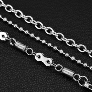 Detailed view of three-tier punk wallet chains in silver steel on black leather