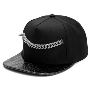 Detail of hip hop snapback cap with crocodile texture brim and spiked diamond chain