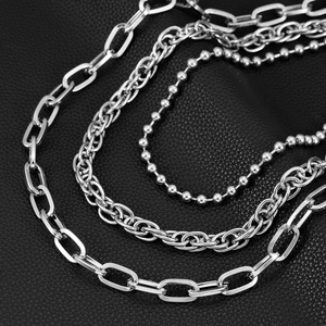 Three-layer silver metallic hip-hop pant chains with polished finish on black leather background