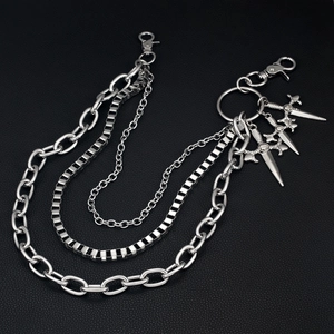 Close-up of triple-layered silver hip hop chain featuring metal sword pendants