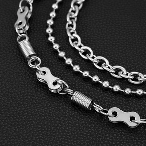 Detailed close-up of triple-layered silver punk wallet chains with industrial metal links