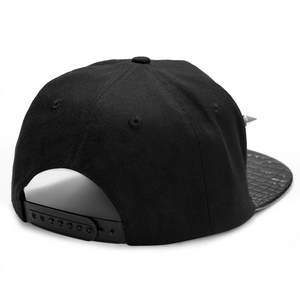 Black street style snapback hat with crocodile texture brim and silver stud rivet details