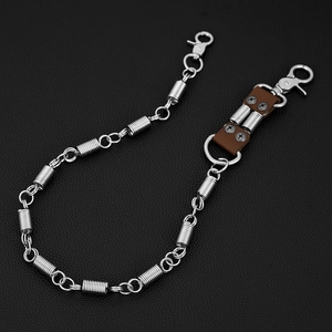 Macro detail of motorcycle style spring chain with brown leather and metal clasp