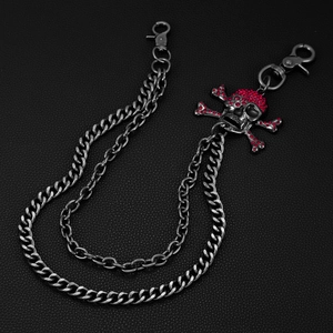 Detail of double-layer punk pants chain with skull pendants and red rhinestones