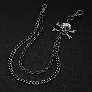 Macro view of double-layer punk pants chain with rhinestone skull crossbones pendant