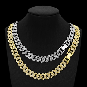 Close-up of gold and silver Cuban link necklaces with micro-paved rhinestones and buckles