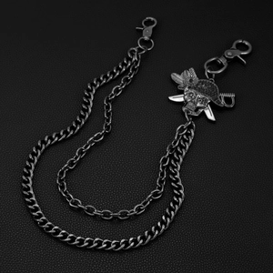 Detailed macro view of gunmetal punk pants chain with a pirate skull and swords pendant