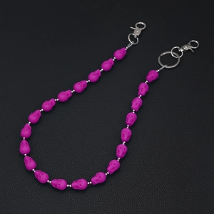 Detailed view of purple skull beads jeans chain with matte finish and metal clasps