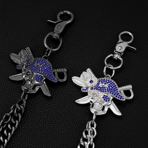 Detailed view of pirate skull pendants with blue rhinestones in silver and gun black finish