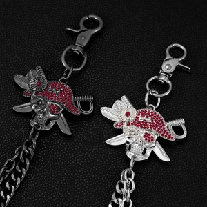 Detail of pirate skull pants chain with red rhinestones and double layer metal chains