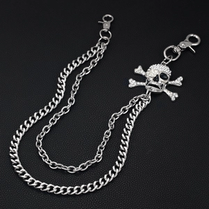 Close-up of double-layer punk chain with skull and crossbones pendant and rhinestones