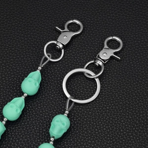 Mint green skull keychain with matte finish and durable metal lobster clasp on leather