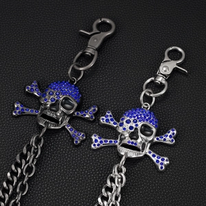 Detail of skull and crossbones punk wallet chains with blue rhinestones on leather