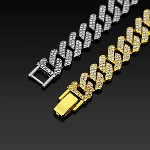Close-up of 14mm iced out Cuban link chain set with gold and silver diamond finish